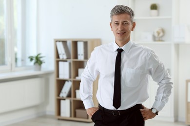 Photo of Portrait of handsome businessman posing in office, space for text