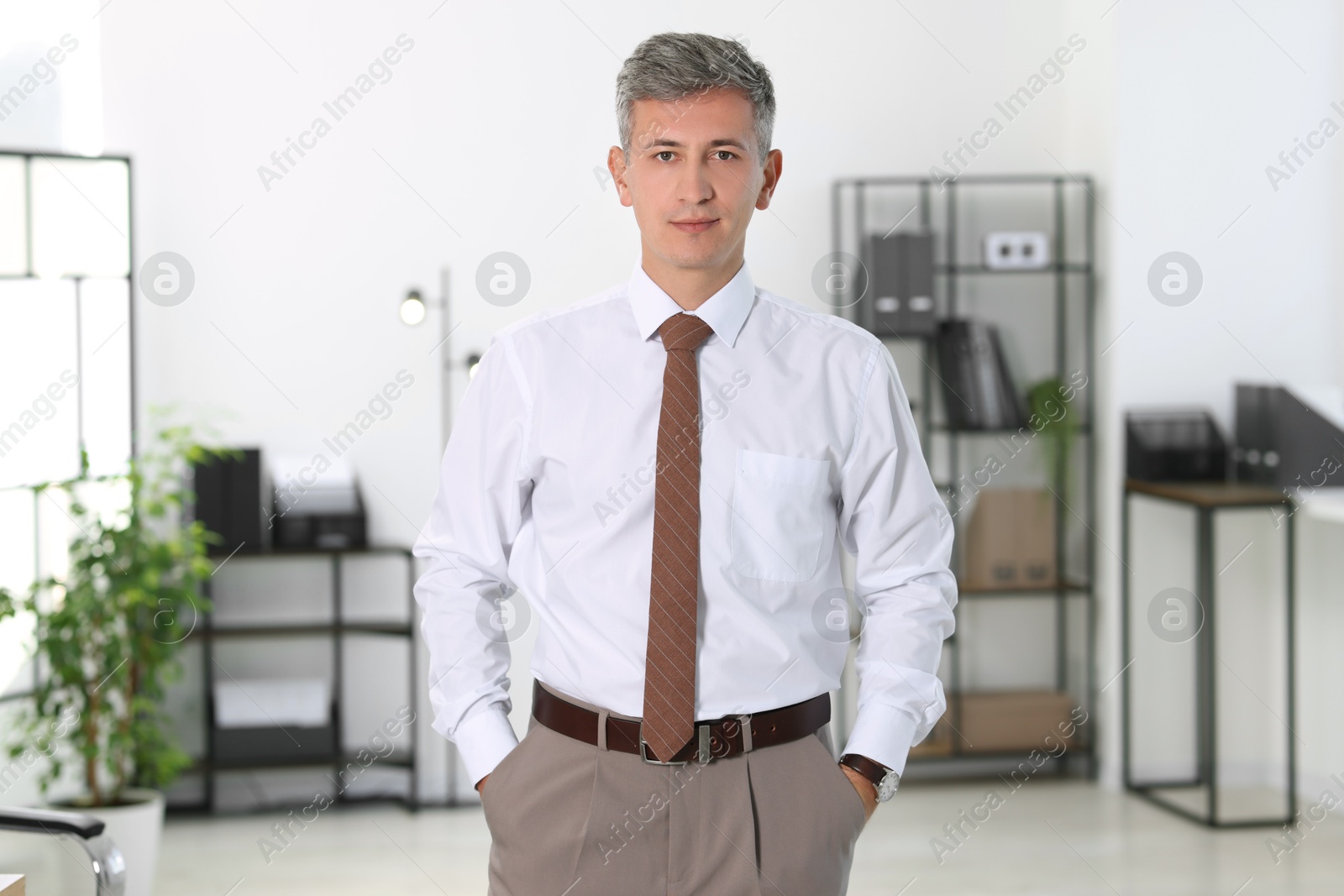 Photo of Portrait of handsome businessman posing in office