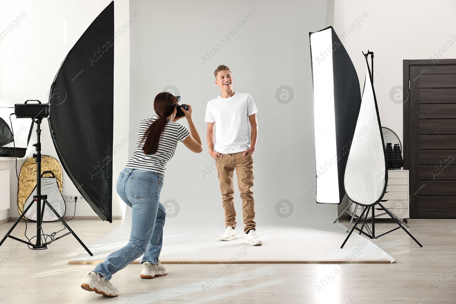 Photo of Photographer working with model in professional photo studio