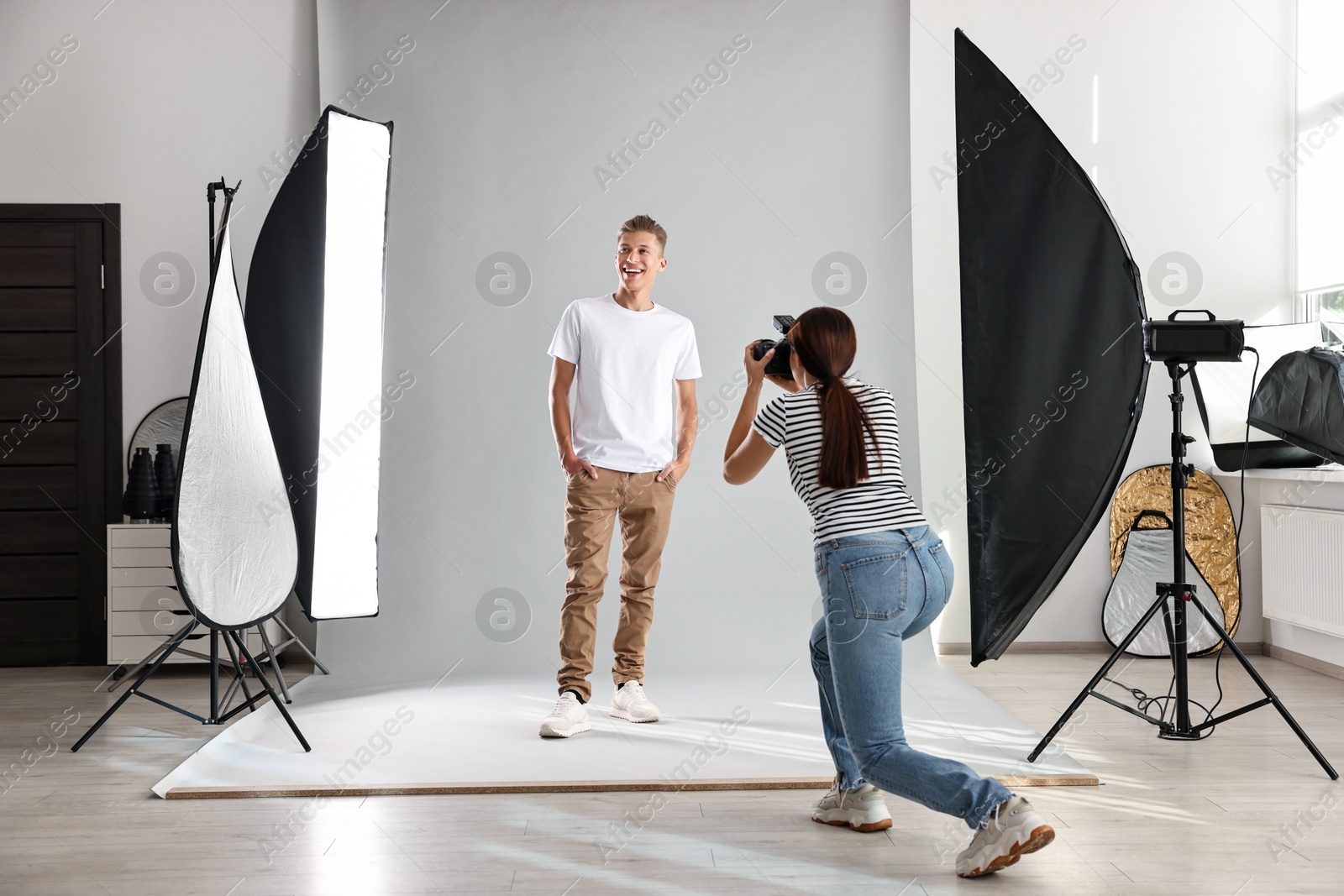 Photo of Photographer working with model in professional photo studio