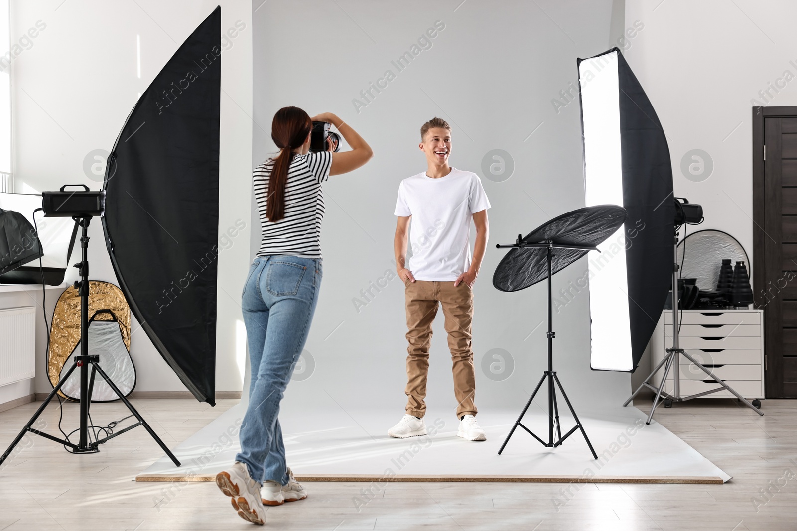 Photo of Photographer working with model in professional photo studio