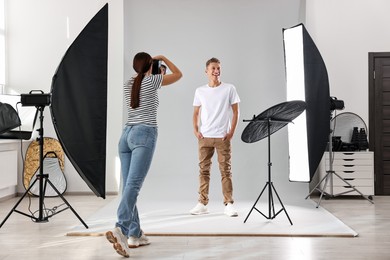 Photo of Photographer working with model in professional photo studio