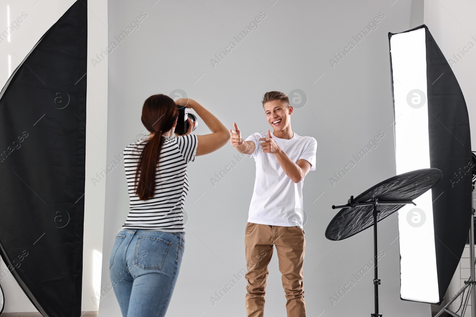 Photo of Photographer working with model in professional photo studio