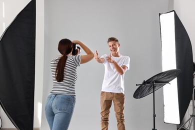 Photo of Photographer working with model in professional photo studio