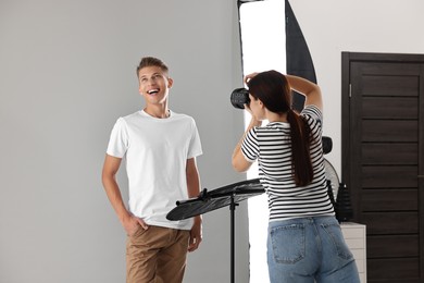 Photo of Photographer working with model in professional photo studio