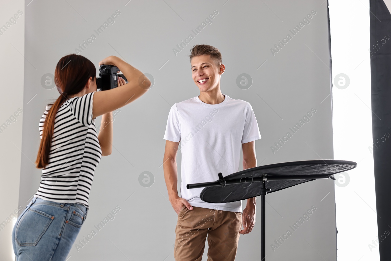 Photo of Photographer working with model in professional photo studio