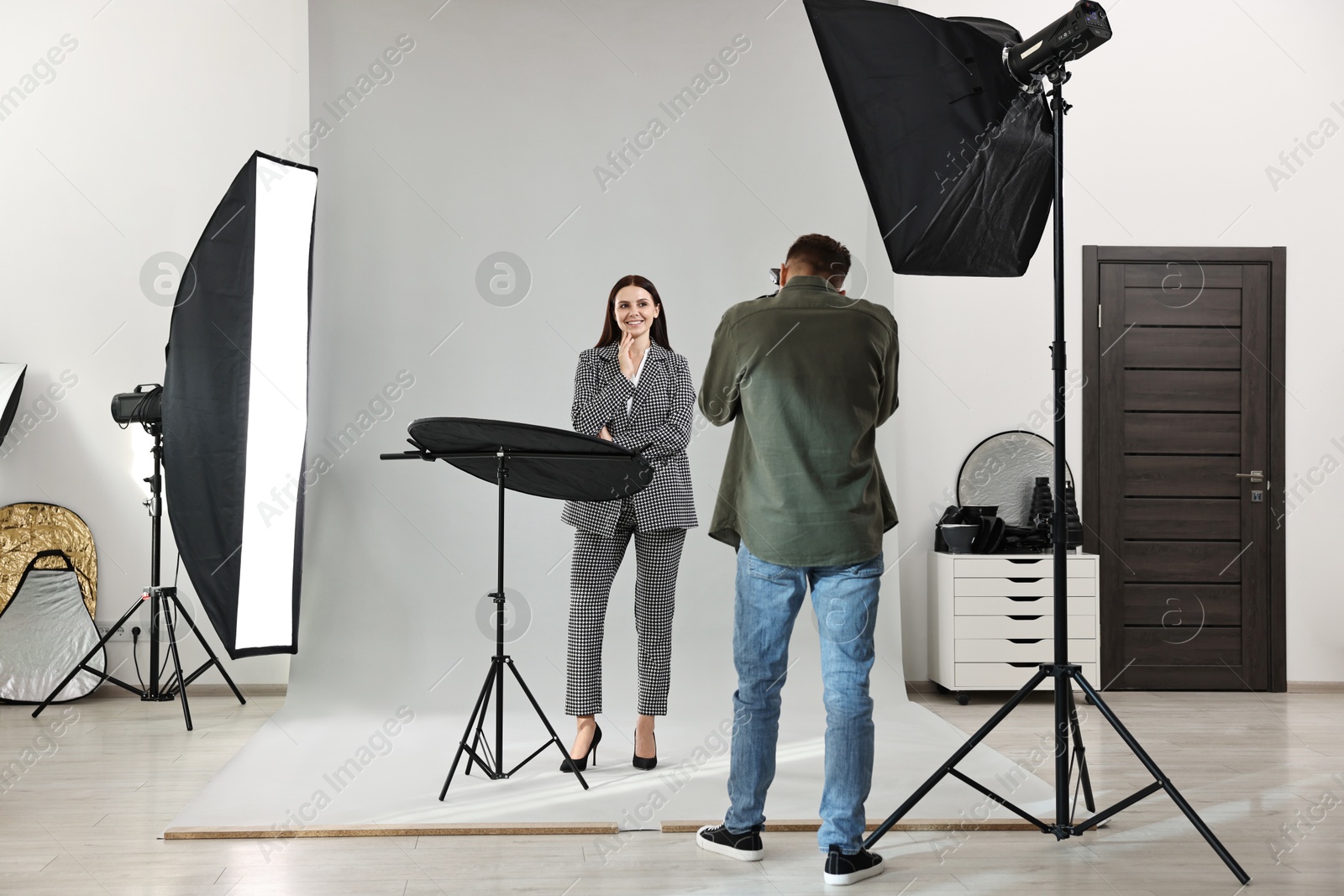 Photo of Photographer working with model in professional photo studio