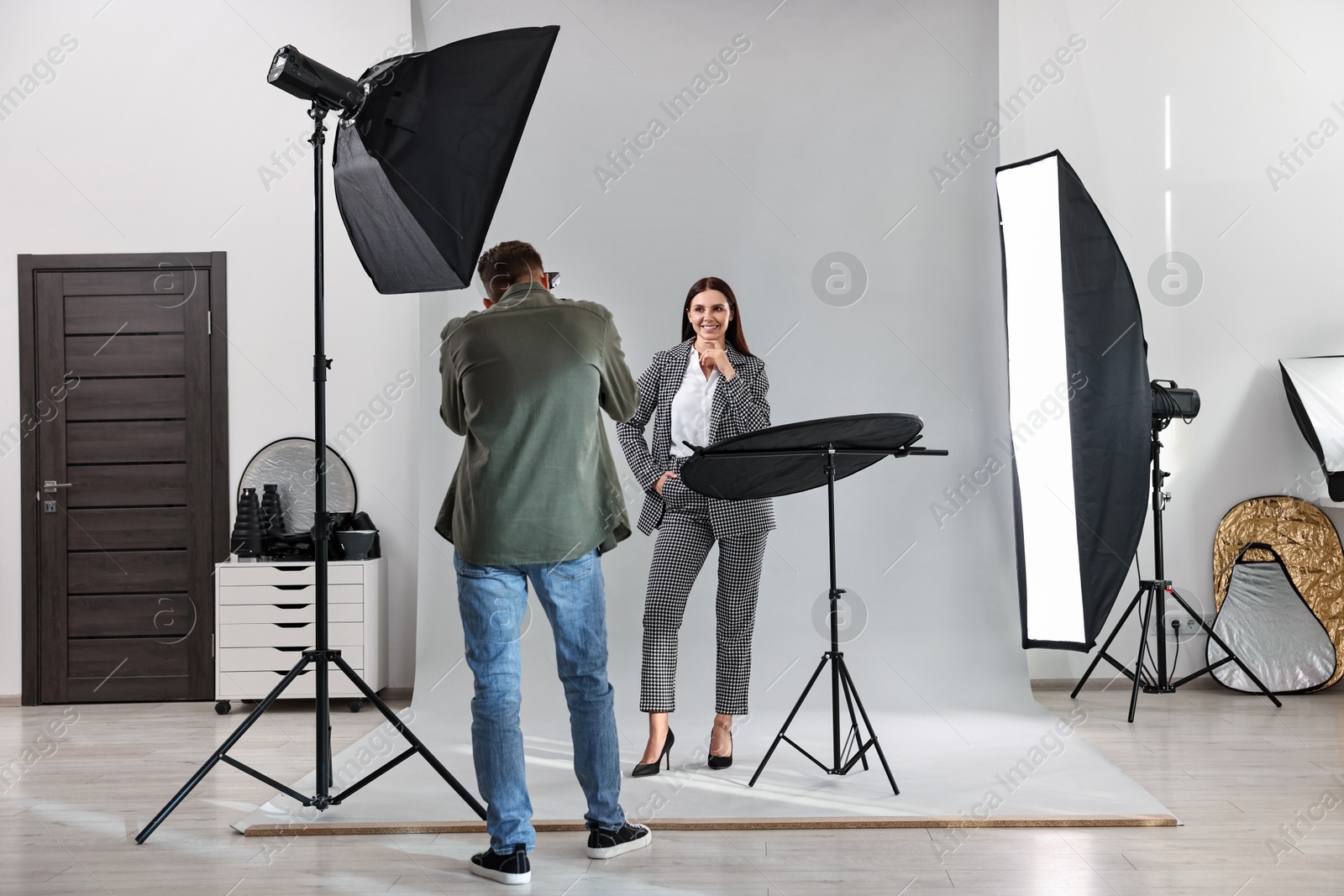 Photo of Photographer working with model in professional photo studio