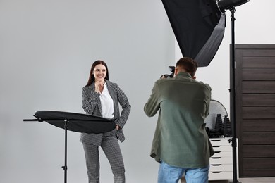 Photo of Photographer working with model in professional photo studio