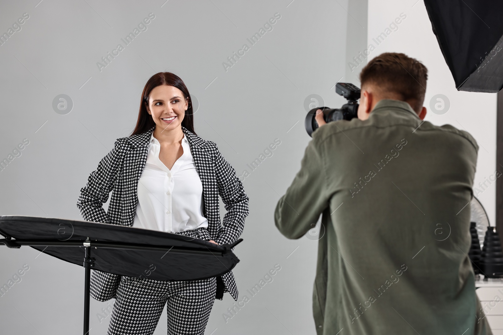 Photo of Photographer working with model in professional photo studio