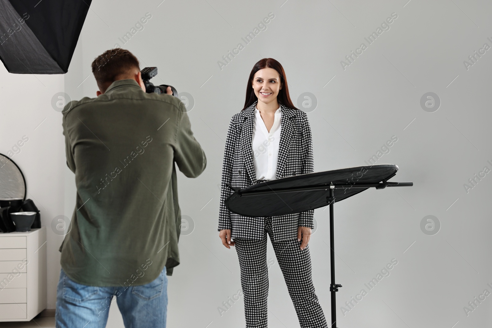 Photo of Photographer working with model in professional photo studio