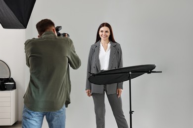 Photo of Photographer working with model in professional photo studio