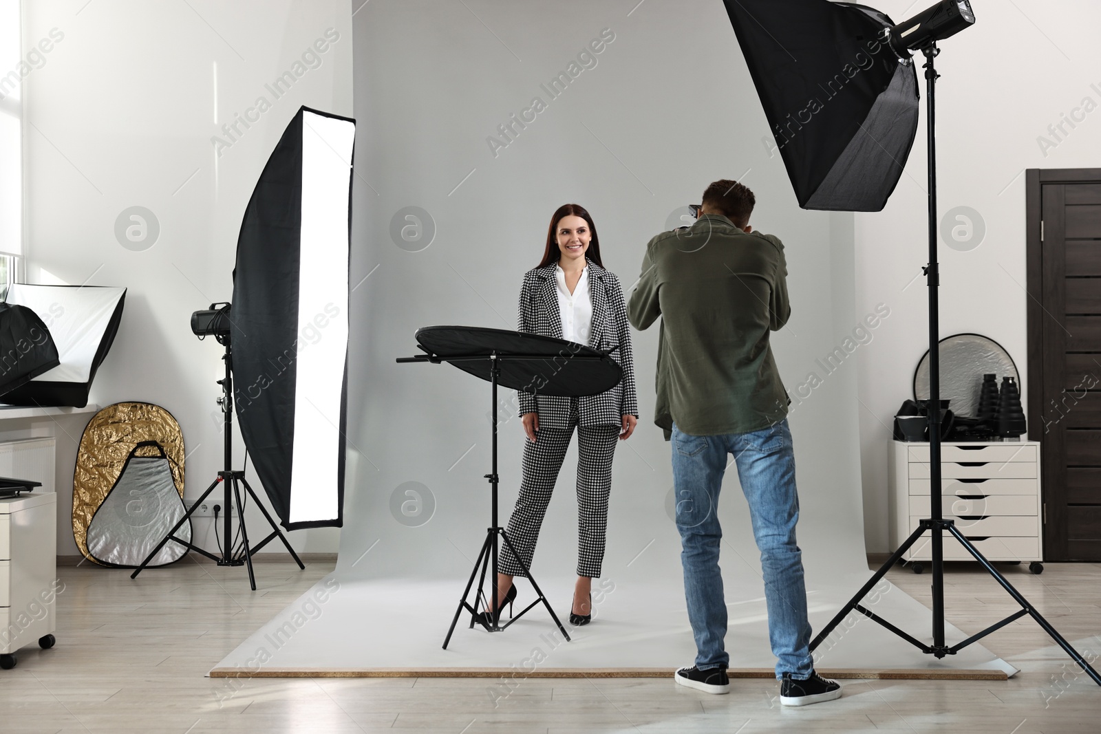 Photo of Photographer working with model in professional photo studio