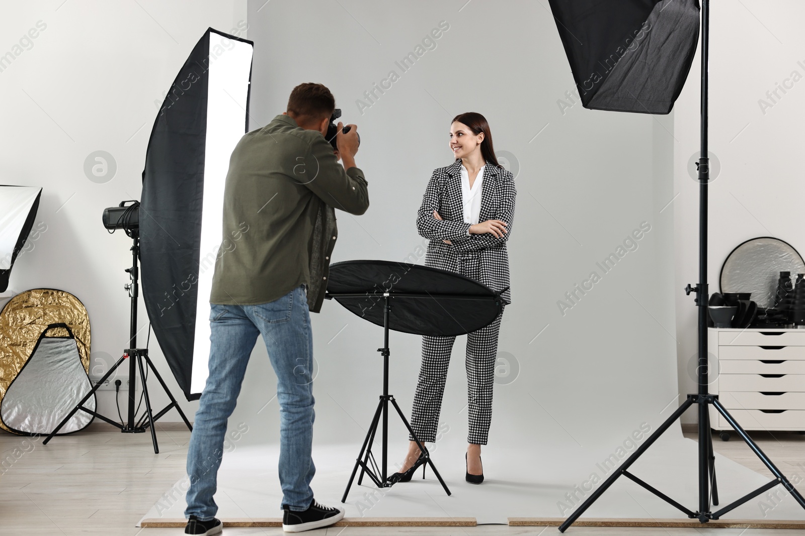 Photo of Photographer working with model in professional photo studio