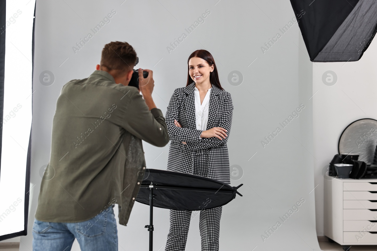 Photo of Photographer working with model in professional photo studio