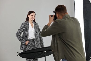 Photo of Photographer working with model in professional photo studio