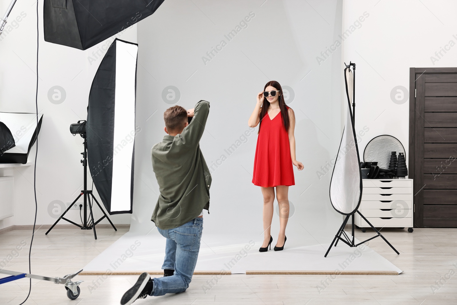 Photo of Photographer working with model in professional photo studio