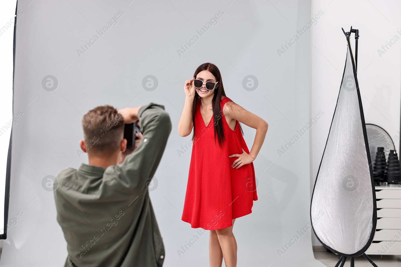 Photo of Photographer working with model in professional photo studio