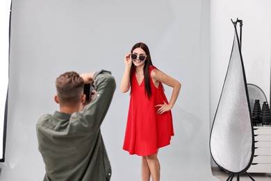 Photo of Photographer working with model in professional photo studio