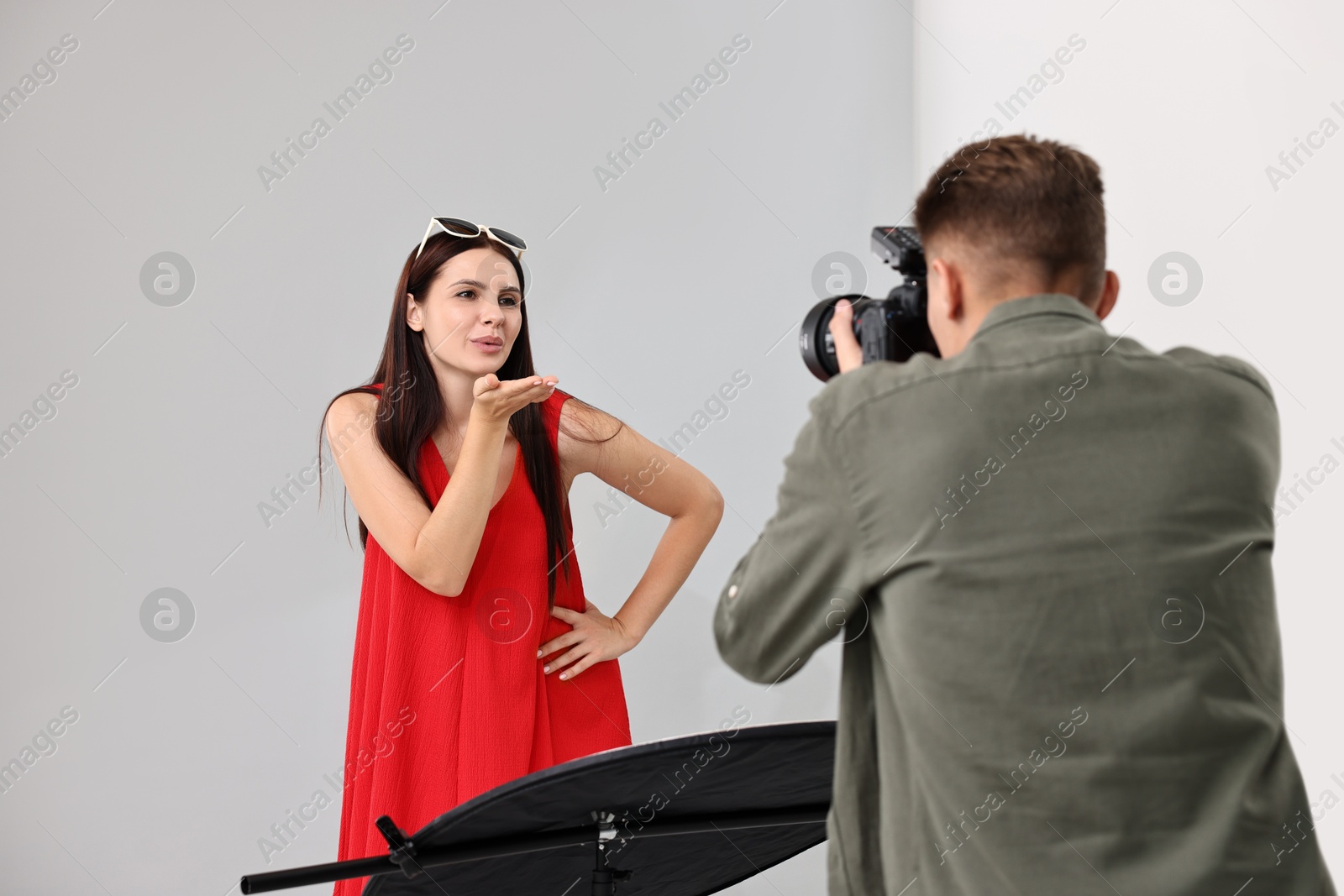 Photo of Photographer working with model in professional photo studio