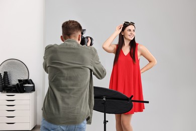 Photo of Photographer working with model in professional photo studio