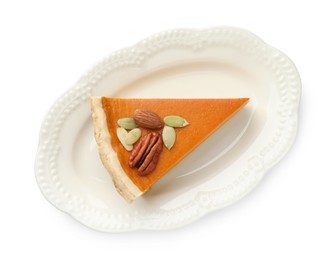 Photo of Piece of tasty homemade pumpkin pie with seeds and nuts isolated on white, top view