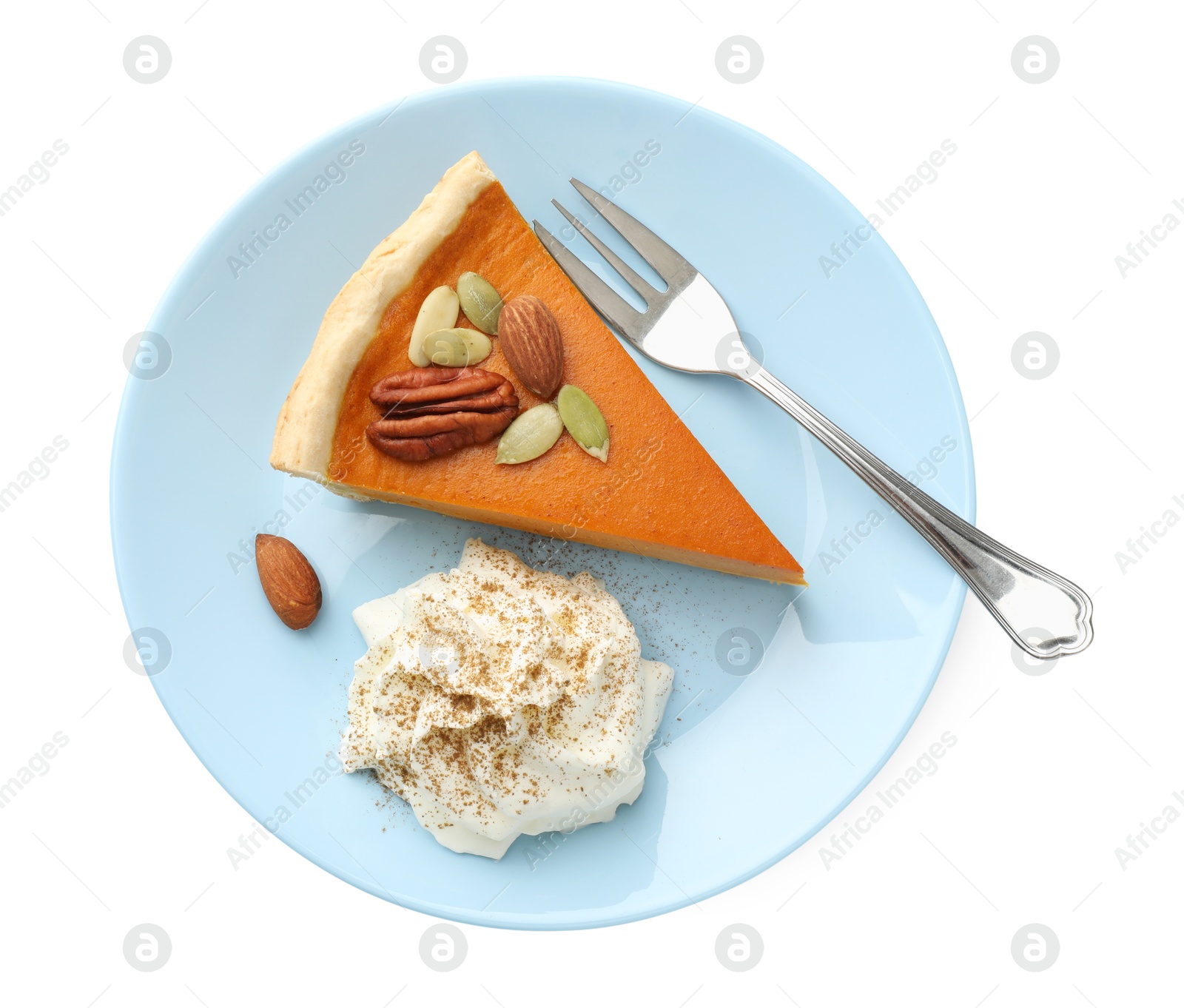 Photo of Piece of tasty homemade pumpkin pie with whipped cream, seeds and nuts isolated on white, top view