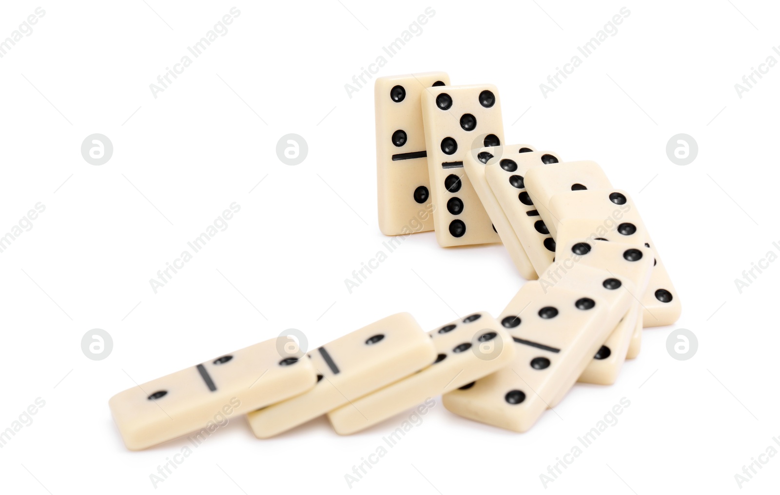 Photo of Domino effect. Tiles falling on white background