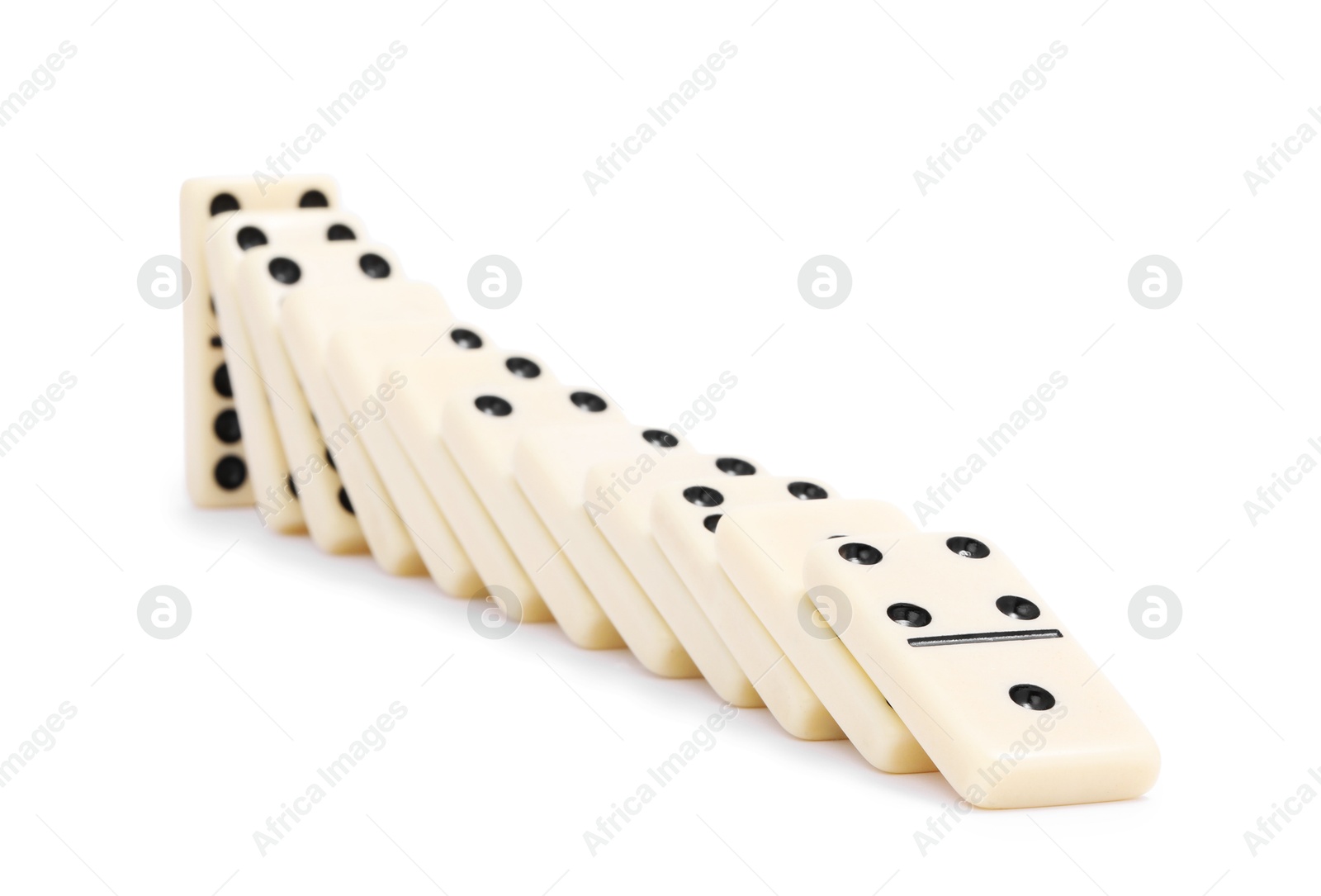 Photo of Domino effect. Tiles falling on white background