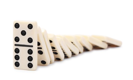 Photo of Domino effect. Tiles falling on white background