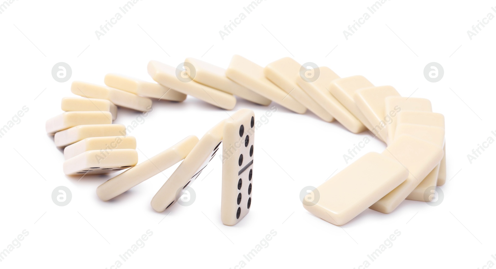 Photo of Domino effect. Tiles falling on white background