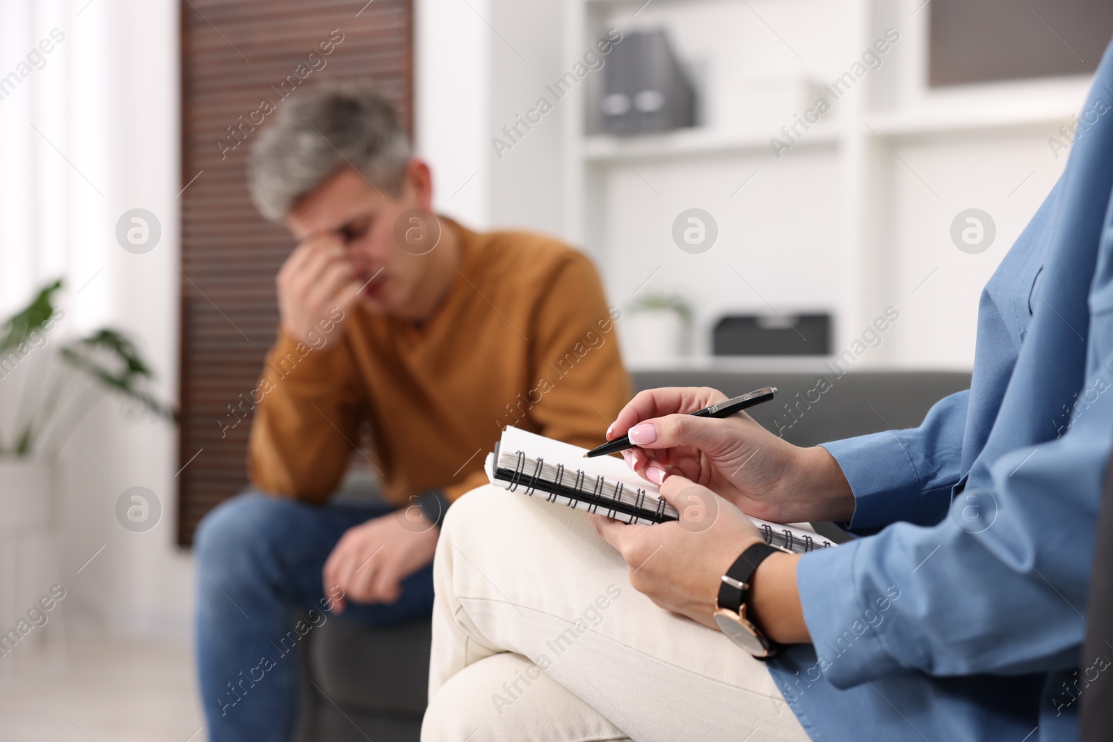 Photo of Professional psychologist working with patient in office, selective focus