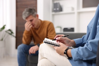 Professional psychologist working with patient in office, selective focus