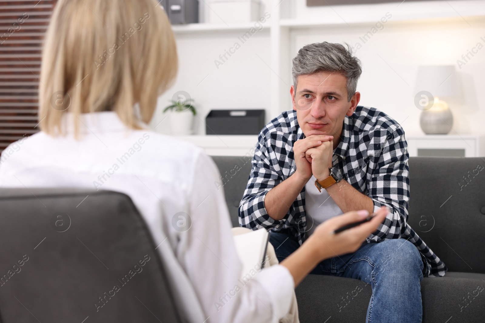 Photo of Professional psychologist working with patient in office