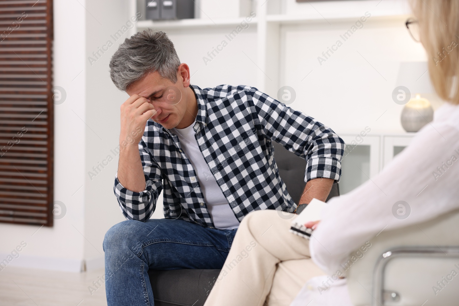 Photo of Professional psychologist working with patient in office, closeup