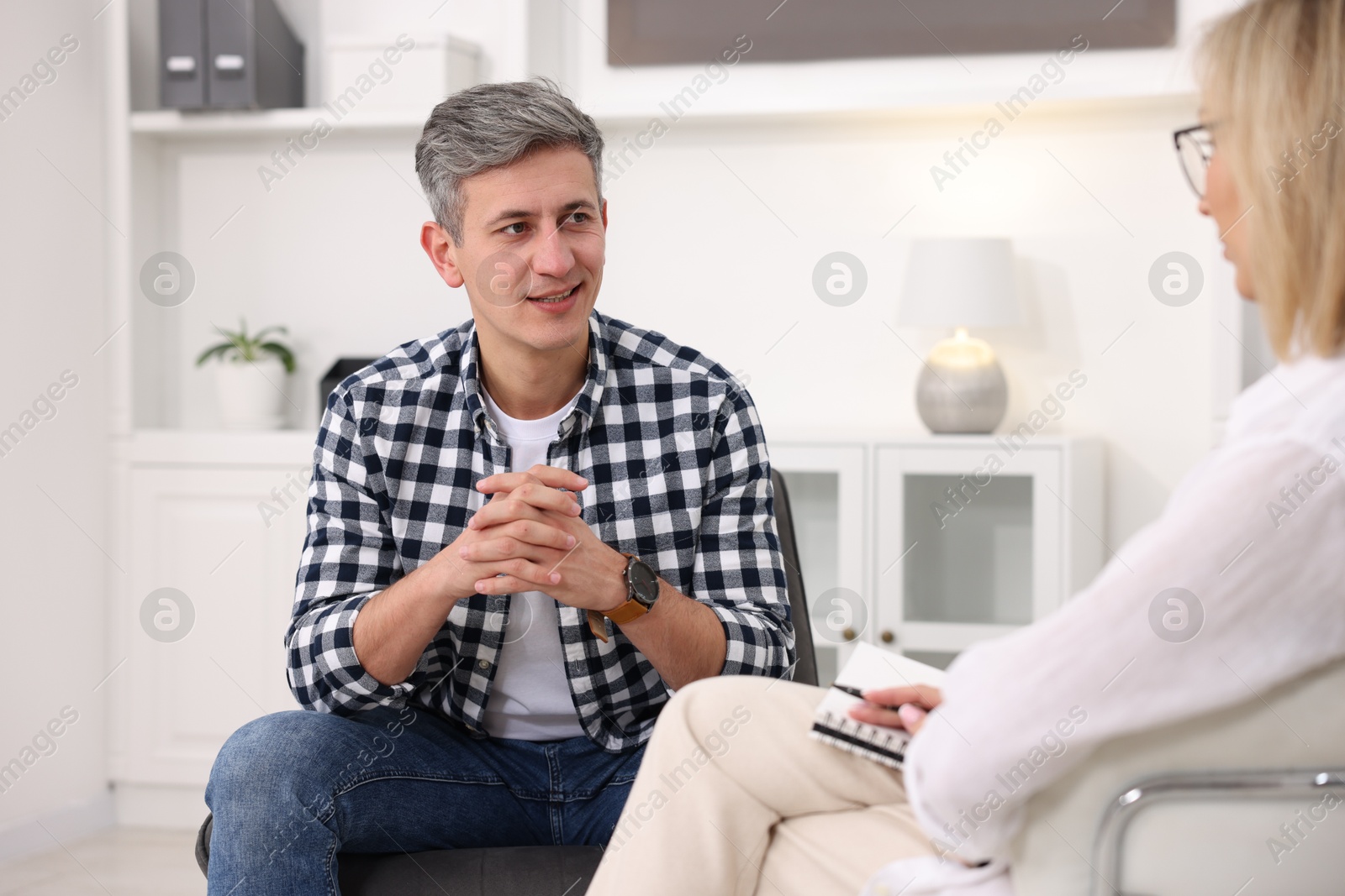 Photo of Professional psychologist working with patient in office, closeup