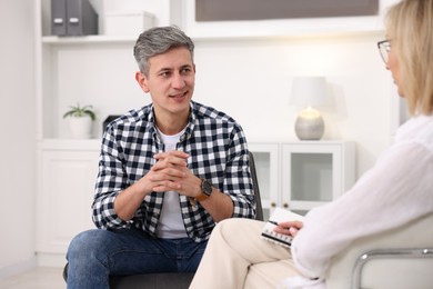 Photo of Professional psychologist working with patient in office, closeup