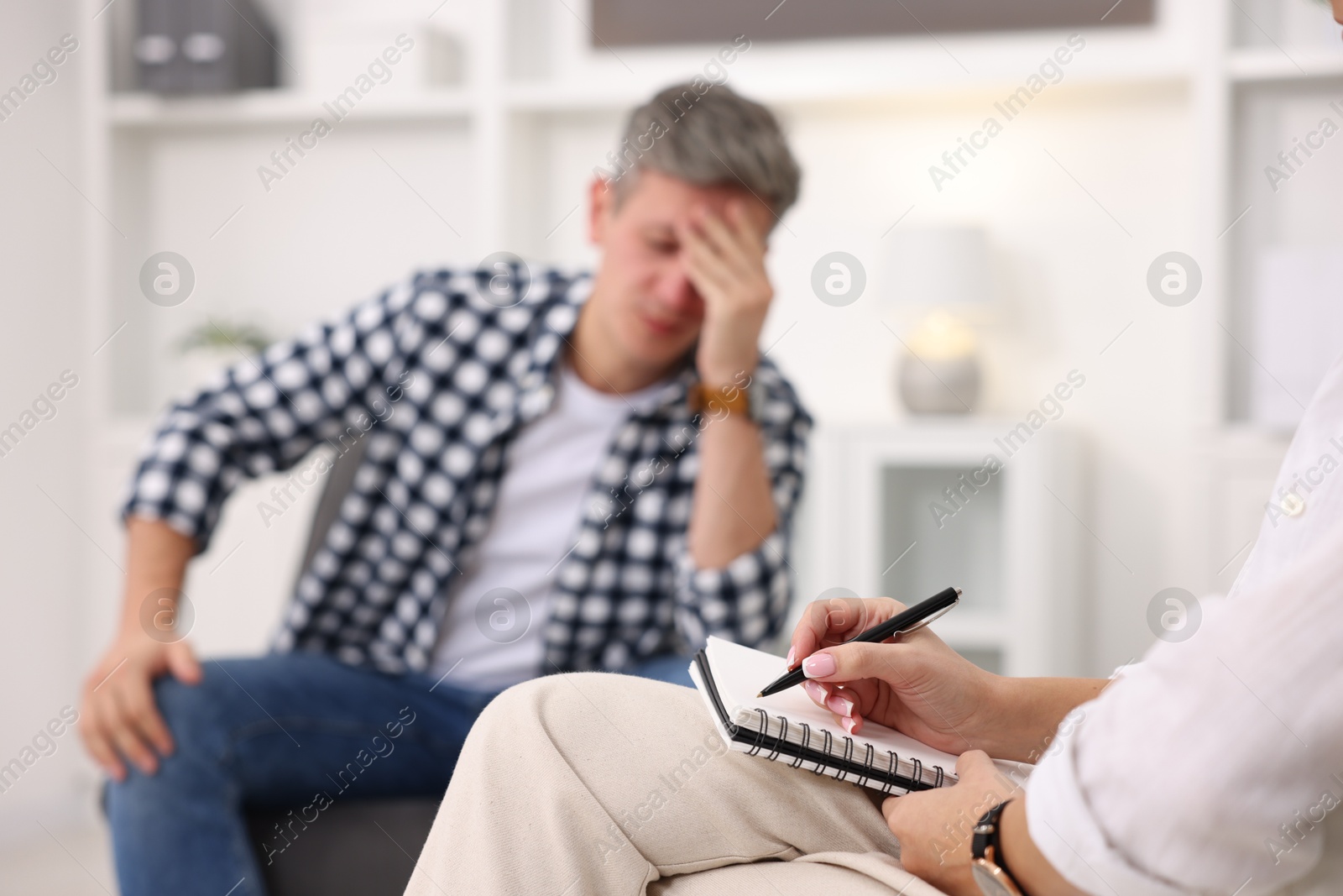 Photo of Professional psychologist working with patient in office, selective focus