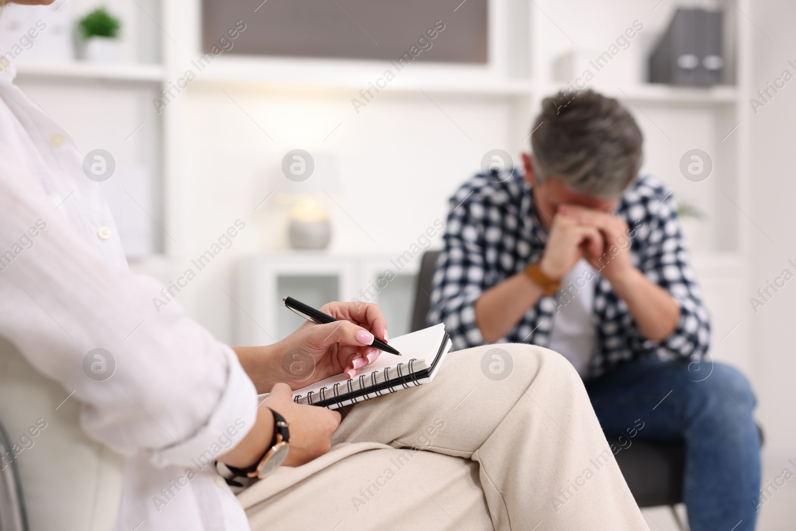 Photo of Professional psychologist working with patient in office, selective focus