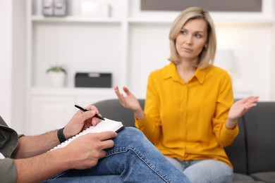 Photo of Professional psychologist working with patient in office, selective focus