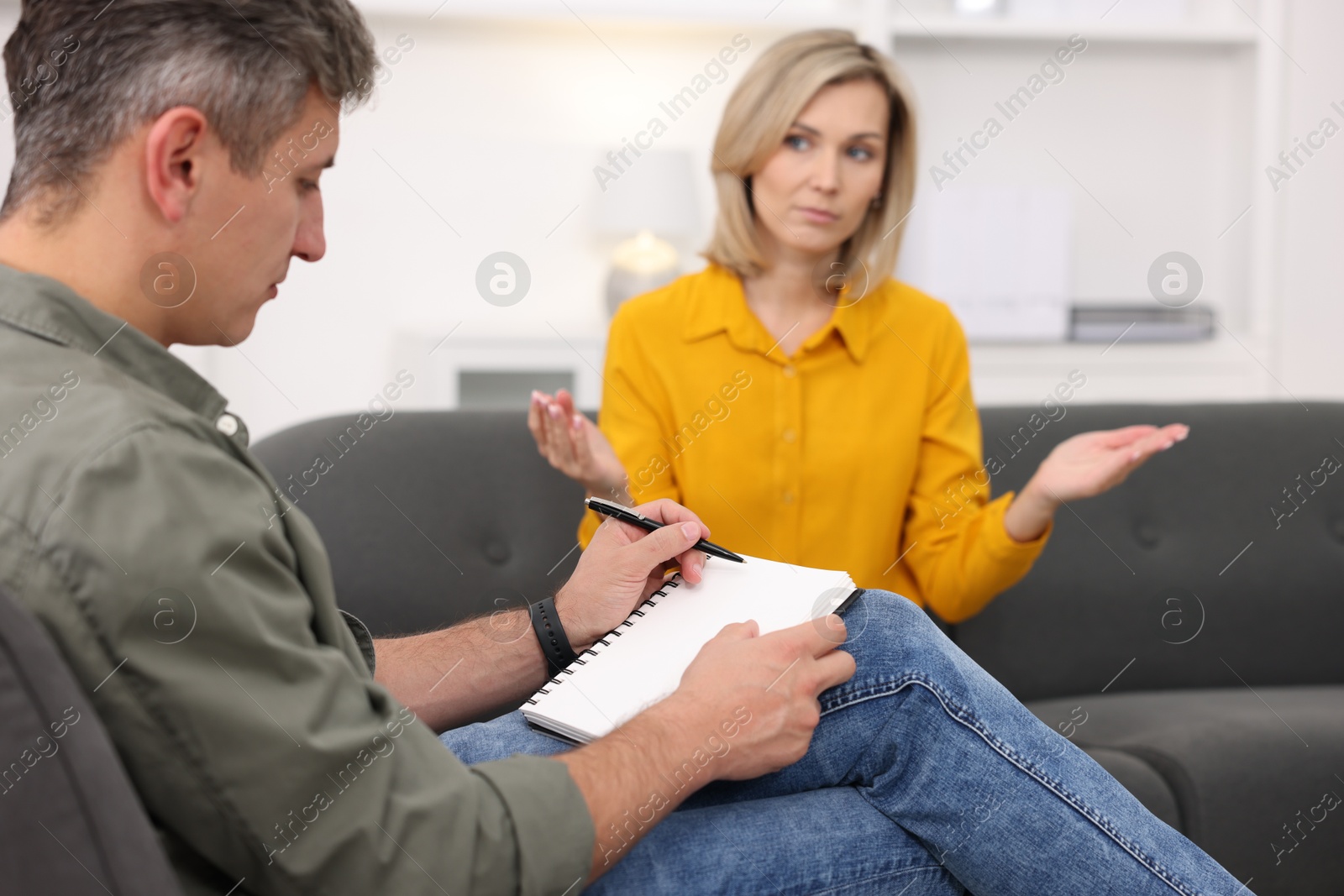 Photo of Professional psychologist working with patient in office, selective focus