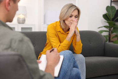 Photo of Professional psychologist working with patient in office, closeup