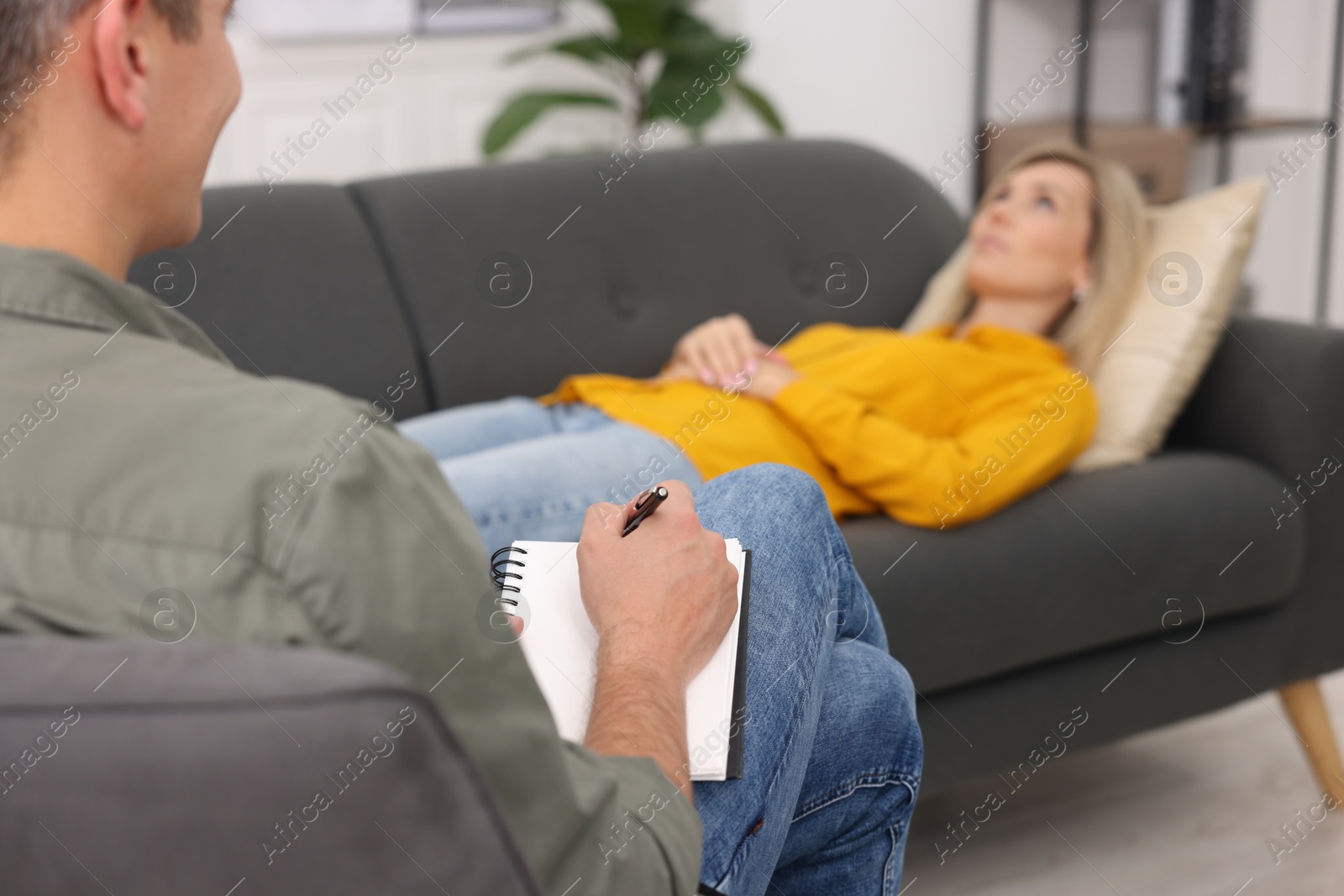 Photo of Professional psychologist working with patient in office, selective focus