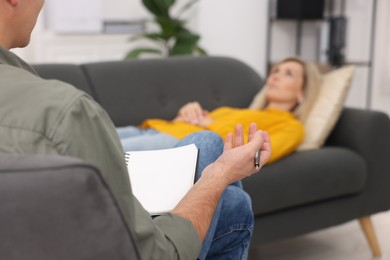 Photo of Professional psychologist working with patient in office, selective focus