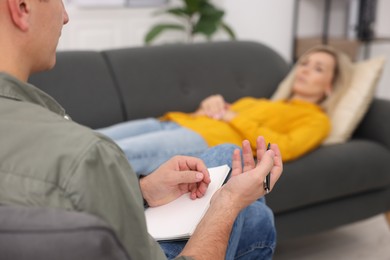 Photo of Professional psychologist working with patient in office, selective focus