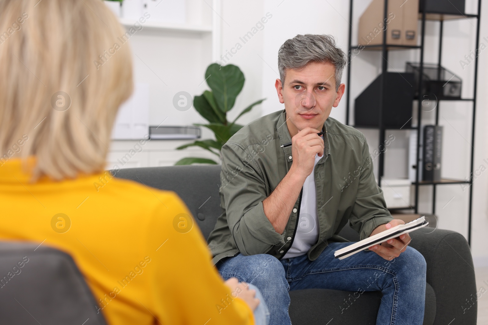 Photo of Professional psychologist working with patient in office