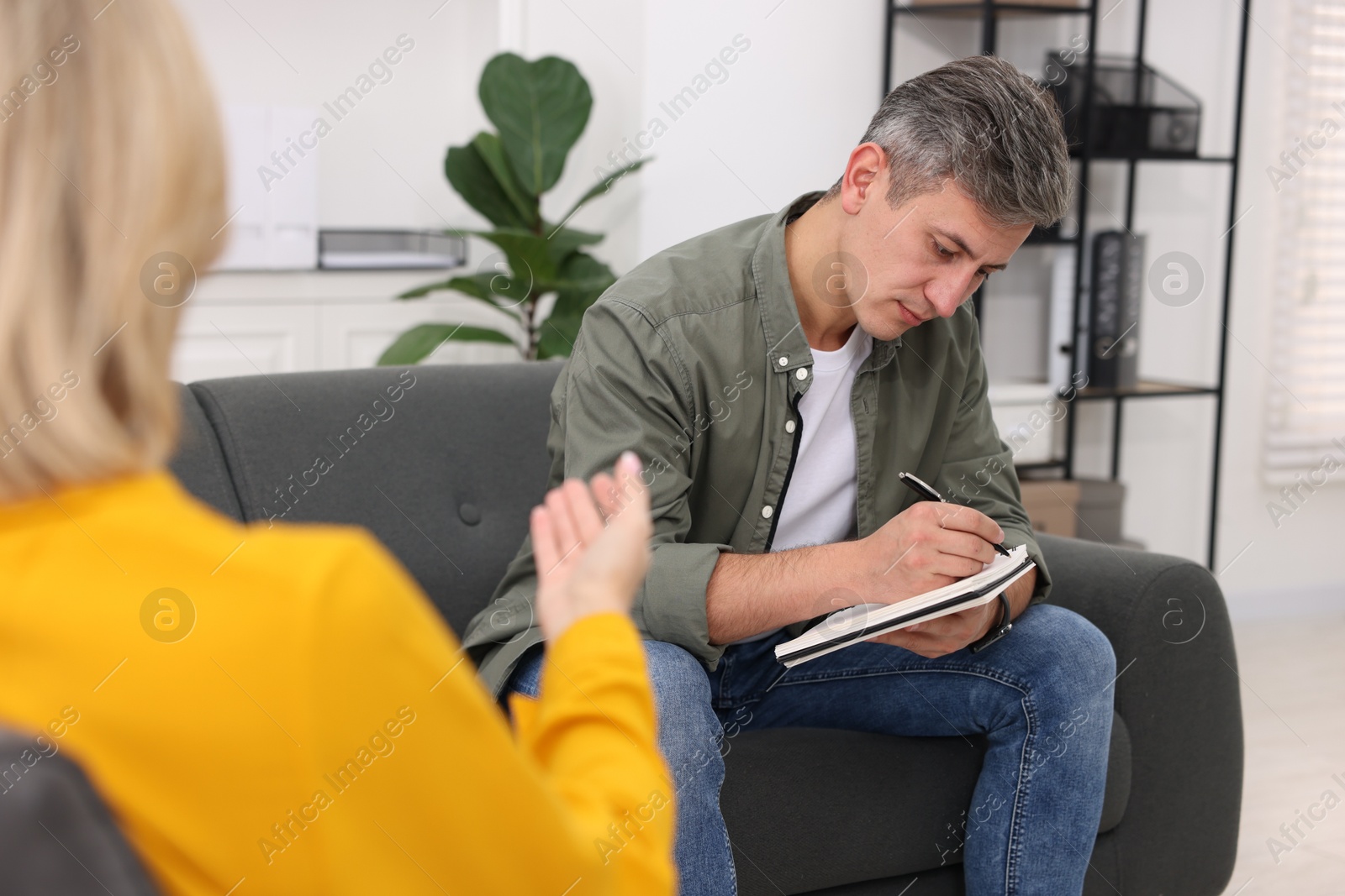 Photo of Professional psychologist working with patient in office