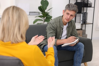 Photo of Professional psychologist working with patient in office