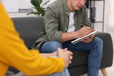 Photo of Professional psychologist working with patient in office, closeup