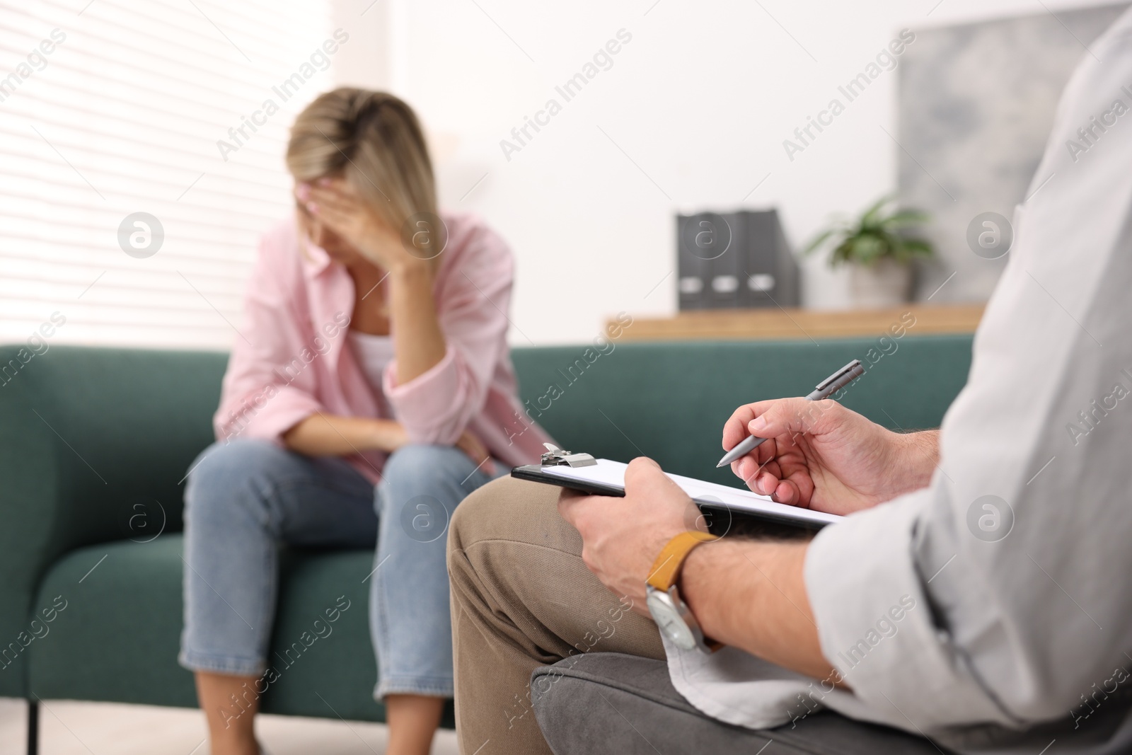 Photo of Professional psychologist working with patient in office, selective focus